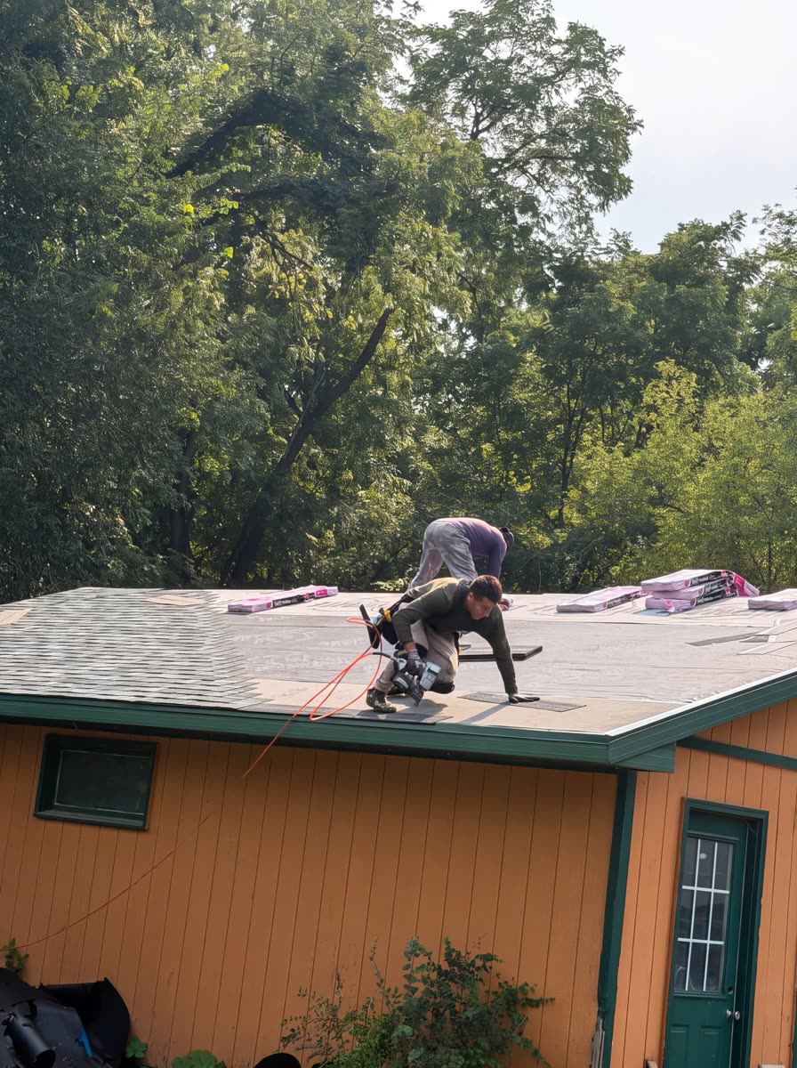 Roofer working on the exposed deck during a St Paul roof replacement